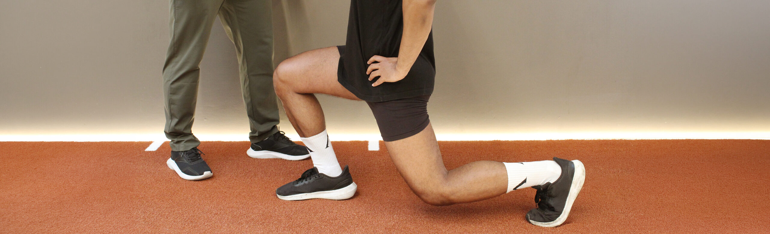 Person performing a lunge exercise at ROOT Physio Physiotherapy clinic London.