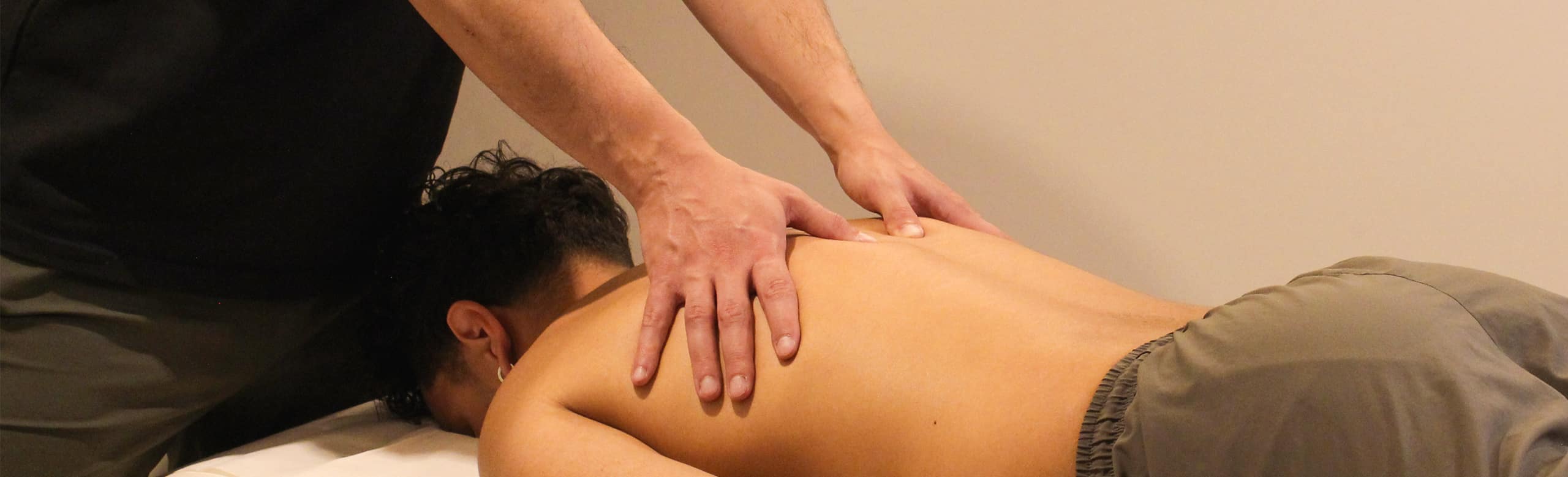 Person receiving massage therapy at ROOT Physio physiotherapy services London.