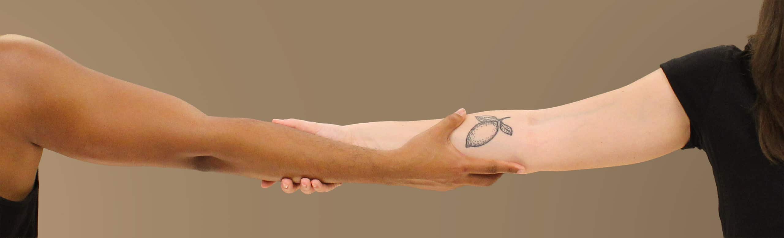 Two people with arms intertwined representing connection at ROOT Physio physiotherapist near me London